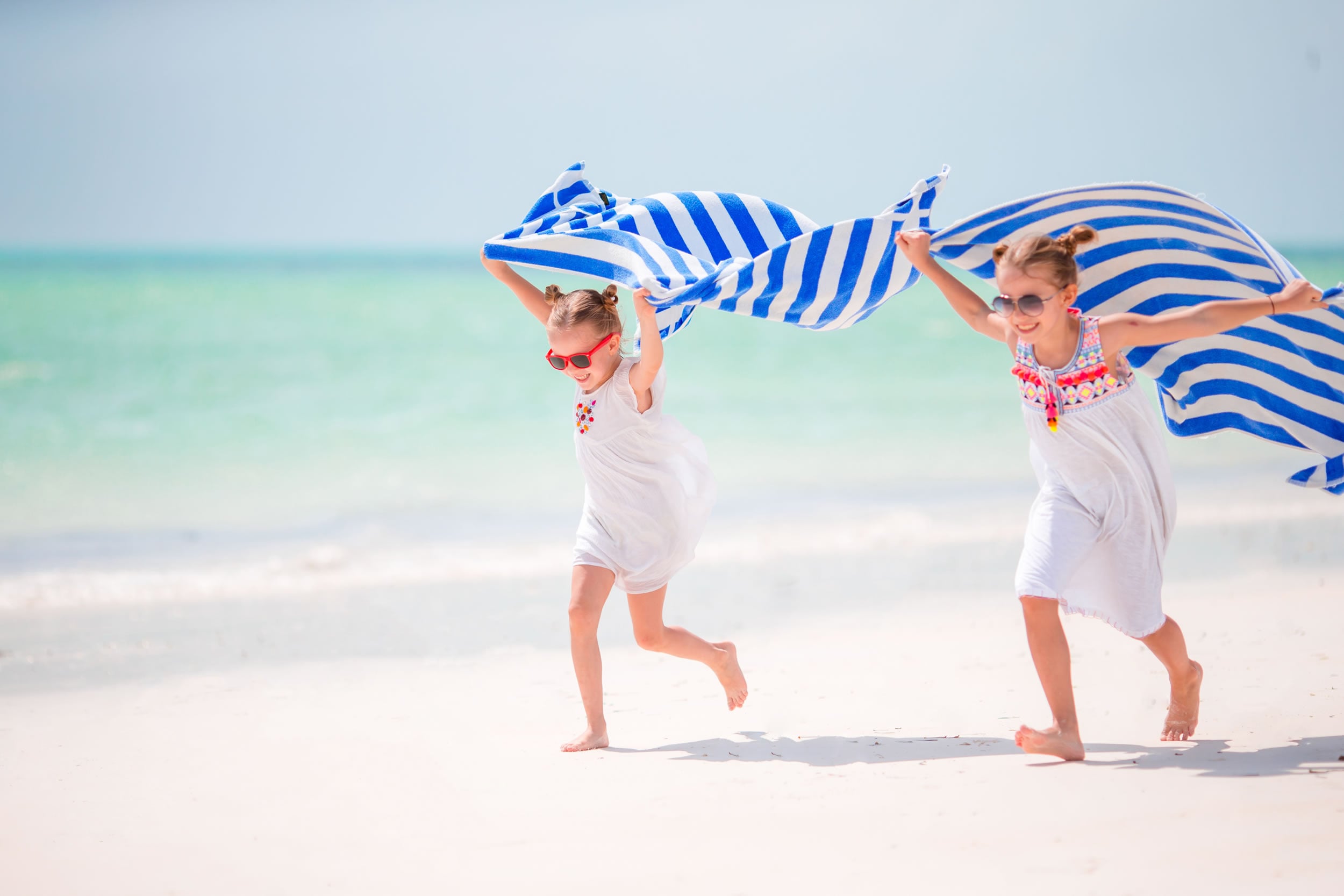 Two girls running on a Greek beach