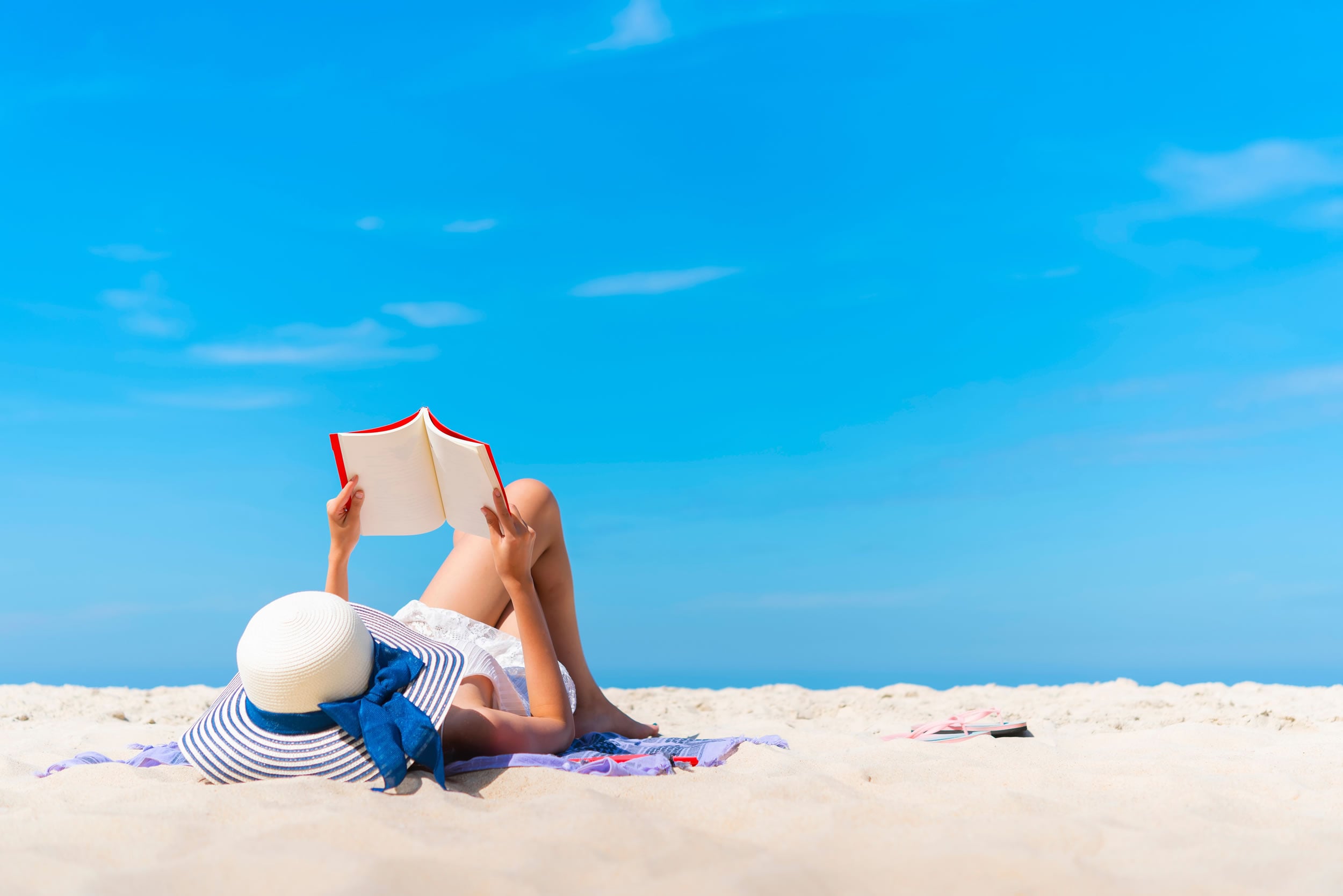 Woman reading a book on a Greek beach